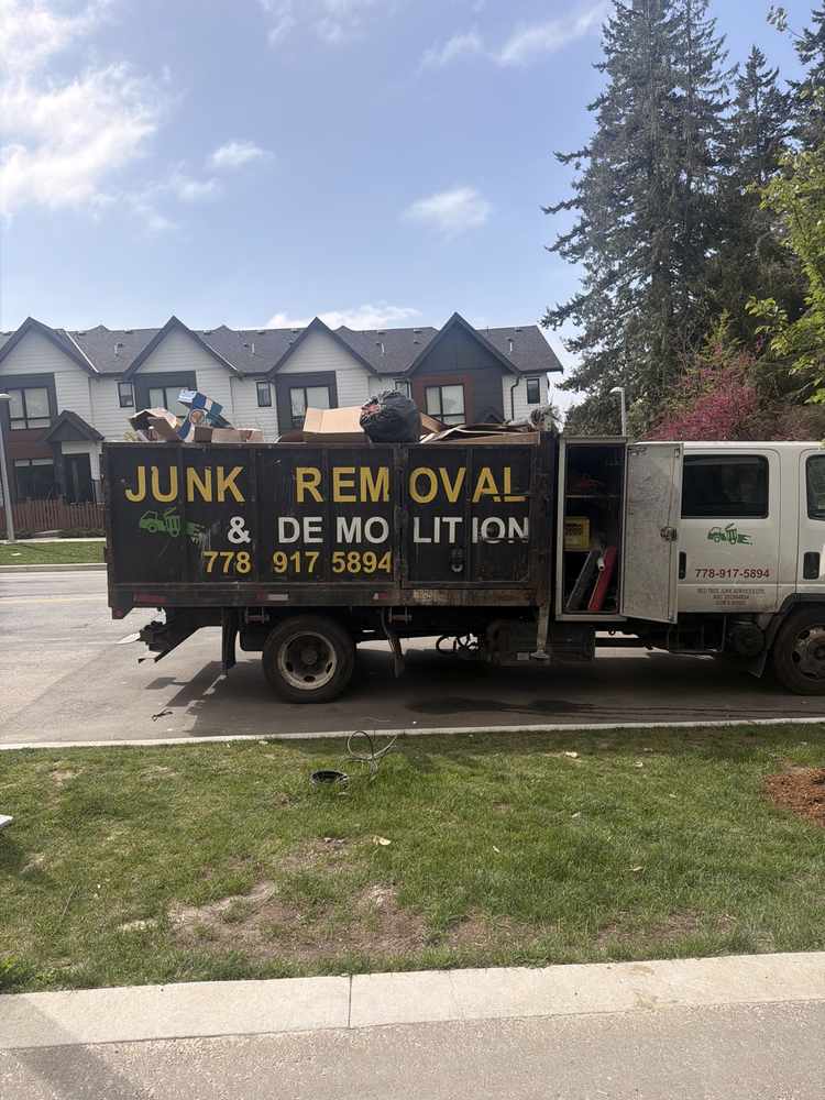 Redtree truck loaded with bagged garbage at a construction site